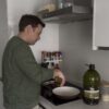Extra Virgin Olive Oil Arbequina 5L · Alfanje 8 A person cooking with olive oil in the kitchen