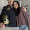 Extra Virgin Olive Oil Arbequina 5L · Alfanje 10 couple posing with a bottle of olive oil 5L