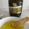 Extra Virgin Olive Oil Arbequina 5L · Alfanje 9 a bottle of a 5L with olive oil on a plate